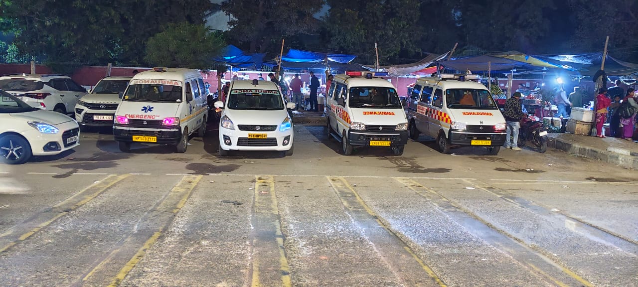 Ambulance fleet parked at night near PGI